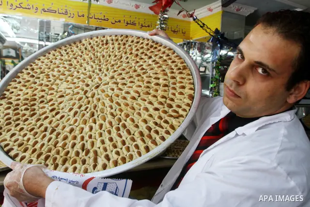 A Palestinian vendor distributes sweets after the results of high school exams, or "Tawjihe", in Gaza city on July 24, 2011. The Ministry of Education in Gaza Strip and the West Bank announced the results together. Photo...