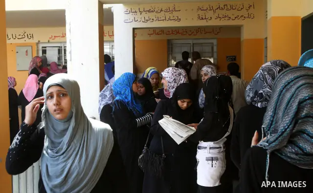 Palestinian secondary school students read a local newspaper to find their results in Gaza city on July 24,2011. The Ministry of Education in Gaza Strip and the West Bank announced the results together. Photo by Ashraf a...