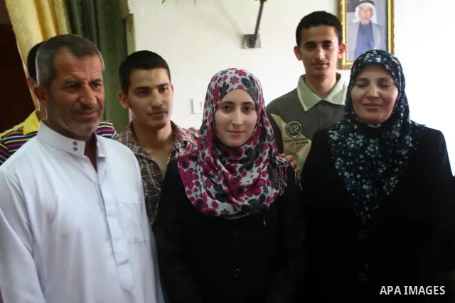 A Palestinian secondary school student and the tenth in section literary, Majd Daher celebrates with her family after received her result in Gaza city on July 24,2011. The Ministry of Education in Gaza Strip and the West...