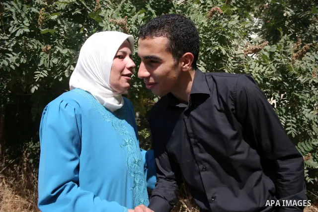A Palestinian student from the top ten in the general secondary certificate in Palestine, Mohammed Jafar Karki with average of 99.5 % , is greeted by his family in the West Bank city of Hebron , Sunday, July 24, 2011. Ph...