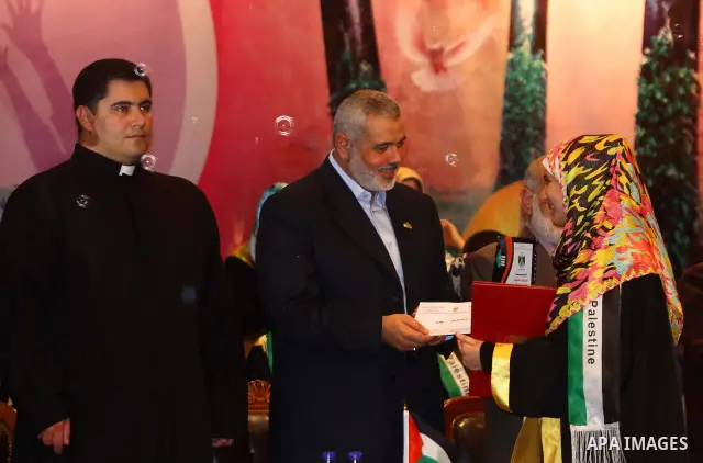 Palestinian Prime Minister in Gaza Strip, Ismail Haniya participates in a celebration in Gaza city on July 24,2011 to honor the students who gained the highest marks in the final high school exams, known as "Tawjihi" at...