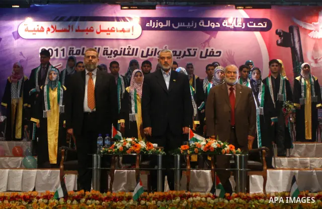 Palestinian Prime Minister in Gaza Strip, Ismail Haniya participates in a celebration in Gaza city on July 24,2011 to honor the students who gained the highest marks in the final high school exams, known as "Tawjihi" at...