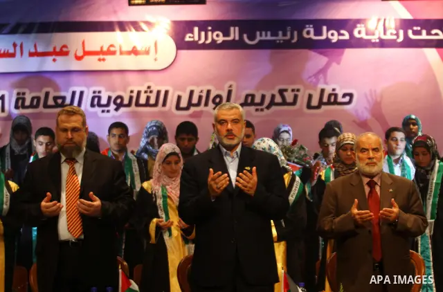 Palestinian Prime Minister in Gaza Strip, Ismail Haniya participates in a celebration in Gaza city on July 24,2011 to honor the students who gained the highest marks in the final high school exams, known as "Tawjihi" at...