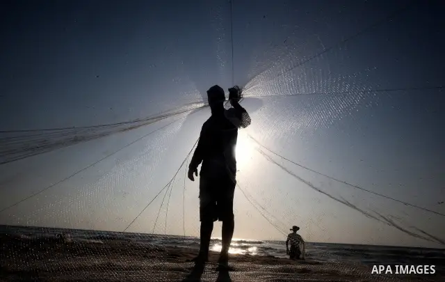 A Palestinian fisherman prepares his nets for fishing at Shatie refugee camp beach, western Gaza city, 24 July 2011. The UN Relief and Works Agency (UNRWA) will reduce some of its services for Palestinian refugees due to...