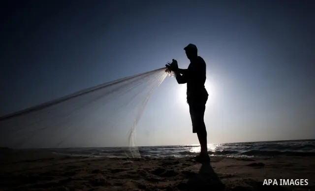 A Palestinian fisherman prepares his nets for fishing at Shatie refugee camp beach, western Gaza city, 24 July 2011. The UN Relief and Works Agency (UNRWA) will reduce some of its services for Palestinian refugees due to...
