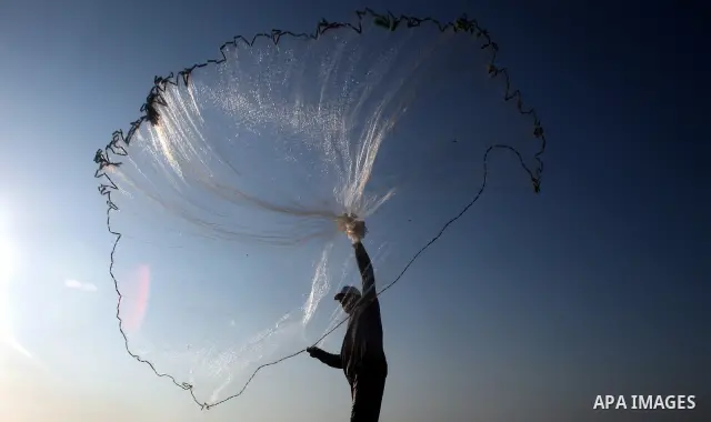 A Palestinian fisherman prepares his nets for fishing at Shatie refugee camp beach, western Gaza city, 24 July 2011. The UN Relief and Works Agency (UNRWA) will reduce some of its services for Palestinian refugees due to...