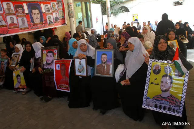 Palestinians women hold pictures of their prisoned relatives in Israeli jails as they gather in a weekly activity calling for their liberty at the Red Cross headquarters in Gaza City on July 25, 2011. About 7000 prisoner...