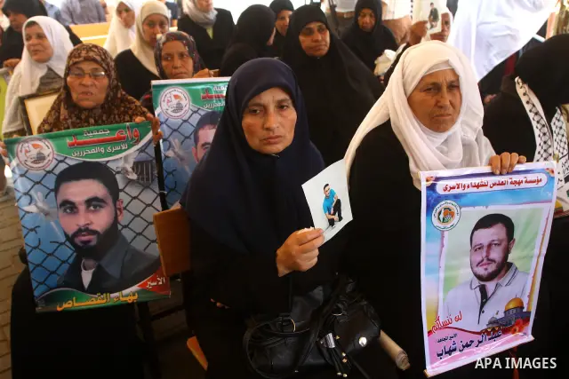 Palestinians women hold pictures of their prisoned relatives in Israeli jails as they gather in a weekly activity calling for their liberty at the Red Cross headquarters in Gaza City on July 25, 2011. About 7000 prisoner...