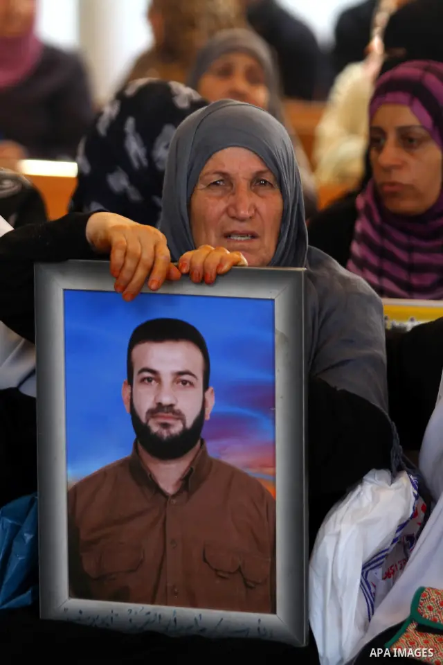 Palestinians women hold pictures of their prisoned relatives in Israeli jails as they gather in a weekly activity calling for their liberty at the Red Cross headquarters in Gaza City on July 25, 2011. About 7000 prisoner...