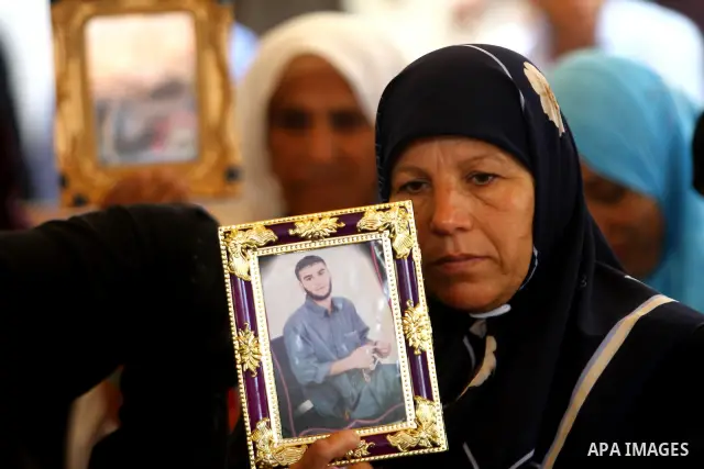Palestinians women hold pictures of their prisoned relatives in Israeli jails as they gather in a weekly activity calling for their liberty at the Red Cross headquarters in Gaza City on July 25, 2011. About 7000 prisoner...