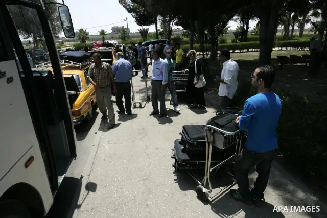 Palestinians load their luggage as they wait to cross the Rafah border crossing with Egypt, in the southern Gaza Strip on July 25, 2011. Photo by Abed Rahim Khatib