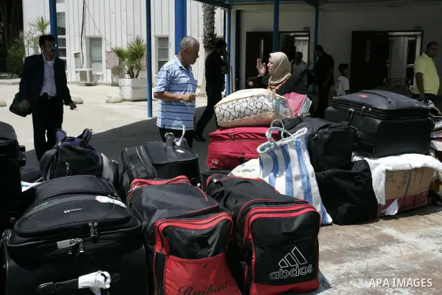 Palestinians load their luggage as they wait to cross the Rafah border crossing with Egypt, in the southern Gaza Strip on July 25, 2011. Photo by Abed Rahim Khatib