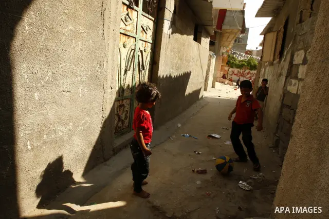 Palestinian boys play football in front of their house Al Shate` refugee camp in the west of Gaza City on July 25, 2011. Photo by Mahmud Nassar