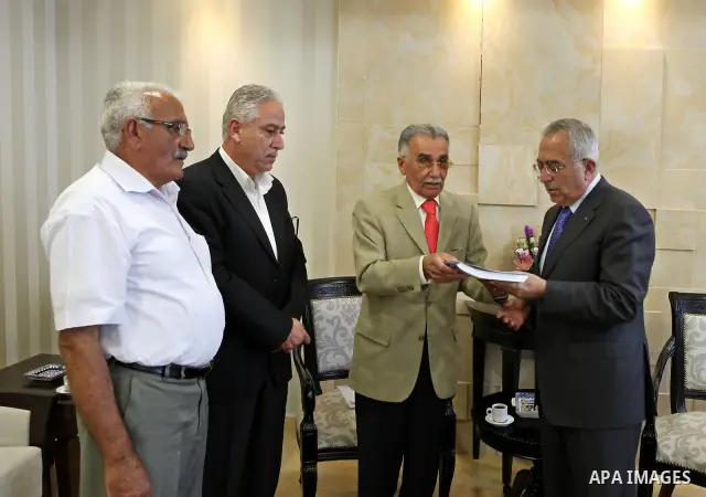 Palestinian Prime Minister, Salam Fayyad receives a report of the fact-finding in the case of bread in the West Bank city of Ramallah on July 25, 2011. Photo by Mustafa Abu Dayeh