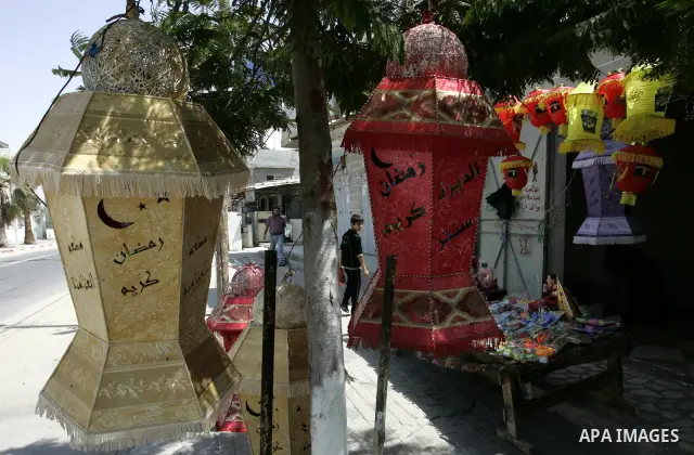 A Palestinian vendor displays a giant lanterns, traditionally used as decoration during the Muslim holy month of Ramadan at a shop in Rafah, southern Gaza Strip on July 26, 2011. The start of Ramadan in the ninth of the...