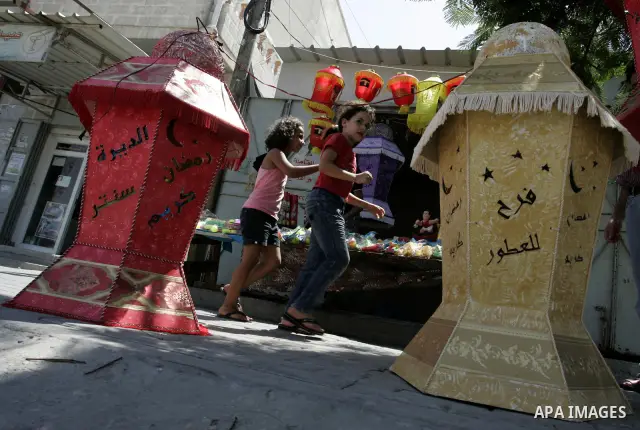 A Palestinian vendor displays a giant lanterns, traditionally used as decoration during the Muslim holy month of Ramadan at a shop in Rafah, southern Gaza Strip on July 26, 2011. The start of Ramadan in the ninth of the...
