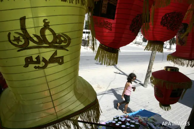A Palestinian vendor displays a giant lanterns, traditionally used as decoration during the Muslim holy month of Ramadan at a shop in Rafah, southern Gaza Strip on July 26, 2011. The start of Ramadan in the ninth of the...