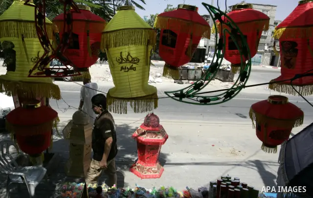 A Palestinian vendor displays a giant lanterns, traditionally used as decoration during the Muslim holy month of Ramadan at a shop in Rafah, southern Gaza Strip on July 26, 2011. The start of Ramadan in the ninth of the...