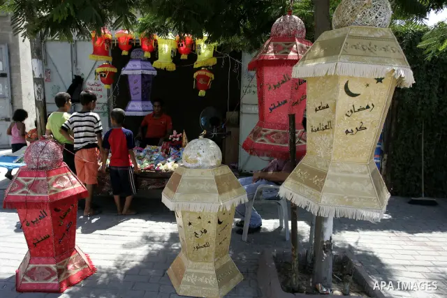 A Palestinian vendor displays a giant lanterns, traditionally used as decoration during the Muslim holy month of Ramadan at a shop in Rafah, southern Gaza Strip on July 26, 2011. The start of Ramadan in the ninth of the...