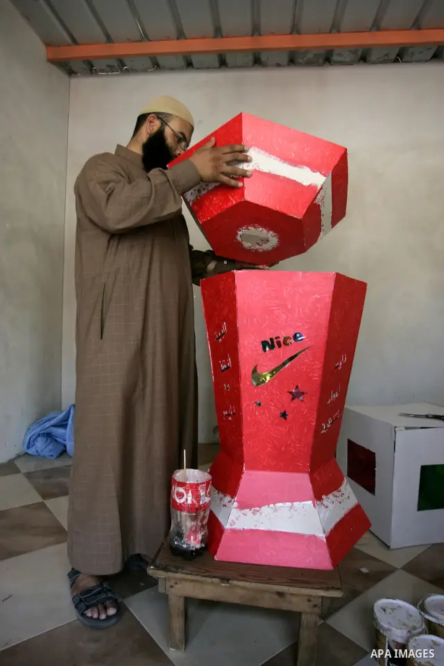 A Palestinian man makes a giant lanterns, traditionally used as decoration during the Muslim holy month of Ramadan at a shop in Rafah, southern Gaza Strip on July 26, 2011. The start of Ramadan in the ninth of the Muslim...