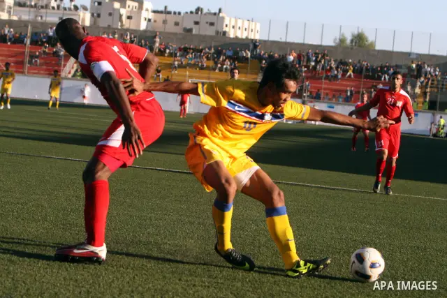Palestinian's team and Thailand's team fight for the ball during their 2014 FIFA World Cup qualification soccer match at A-Ram stadium near Jerusalem July 28, 2011. Photo by Issam Rimawi