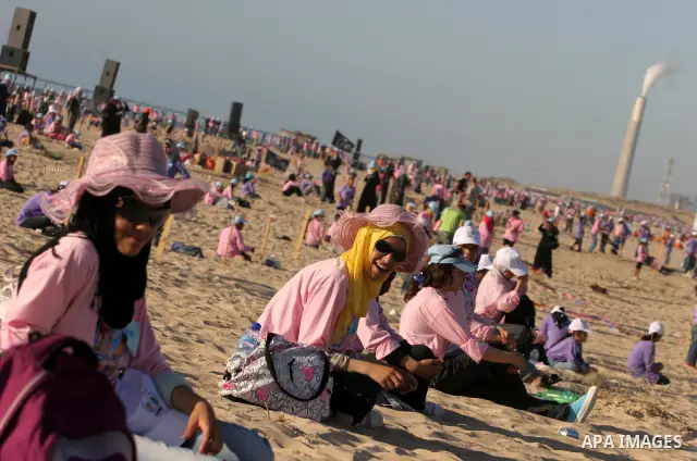Palestinian children fly kites during an event organized by the United Nations Relief and Works Agency (UNRWA), as they seek to achieve a world record for flying kites, in the northern Gaza Strip, Thursday, July 28, 2011...