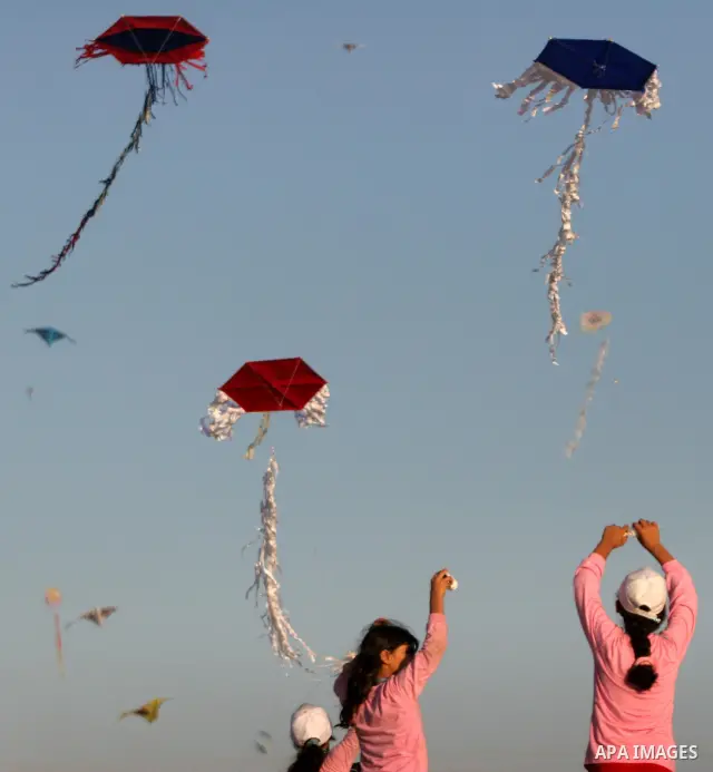 Palestinian children fly kites during an event organized by the United Nations Relief and Works Agency (UNRWA), as they seek to achieve a world record for flying kites, in the northern Gaza Strip, Thursday, July 28, 2011...