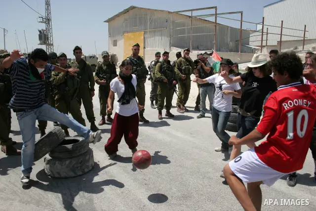 Protesters argue with an Israeli soldiers during a demonstration against Israel's controversial separation barrier in the West Bank village of Maasarah, near the biblical town of Bethlehem on 29 July 2011. Israel says th...
