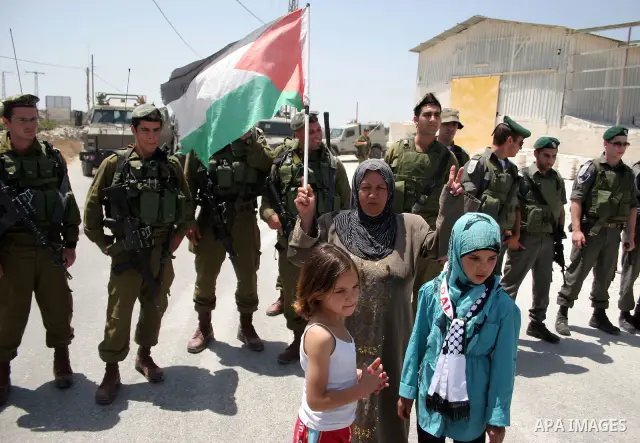 Protesters argue with an Israeli soldiers during a demonstration against Israel's controversial separation barrier in the West Bank village of Maasarah, near the biblical town of Bethlehem on 29 July 2011. Israel says th...