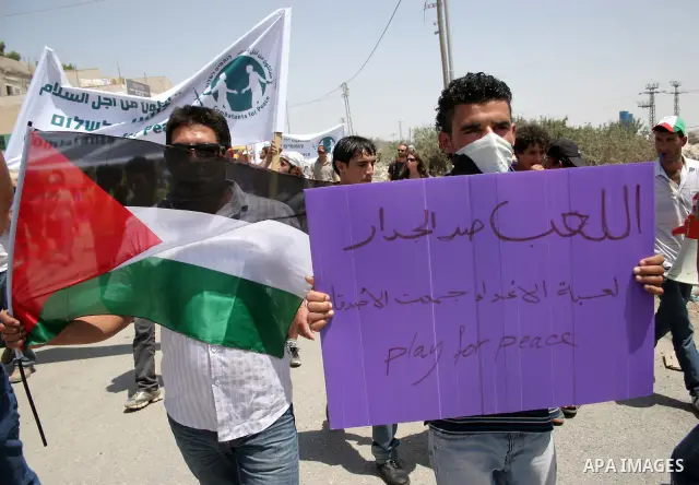 Protesters argue with an Israeli soldiers during a demonstration against Israel's controversial separation barrier in the West Bank village of Maasarah, near the biblical town of Bethlehem on 29 July 2011. Israel says th...