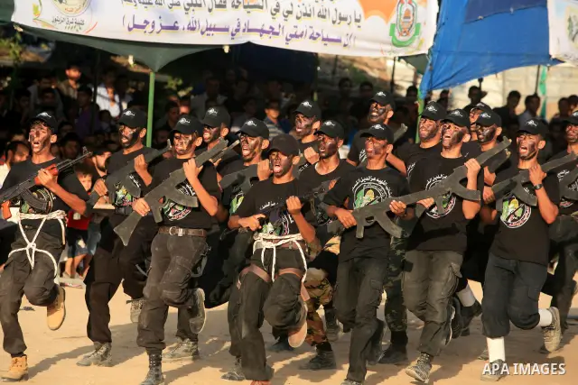 New graduates of a Palestinian Hamas military camp, ages 12-18, perform mock exercises during a graduation ceremony in Gaza City, on July 29, 2011. Photo by Majdi Fathi
