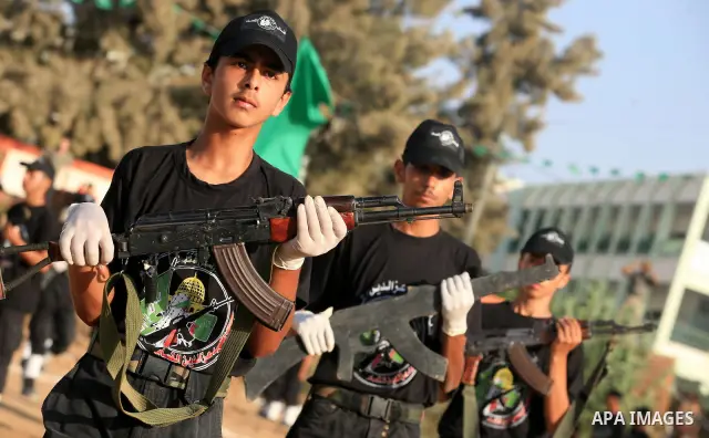 New graduates of a Palestinian Hamas military camp, ages 12-18, perform mock exercises during a graduation ceremony in Gaza City, on July 29, 2011. Photo by Majdi Fathi