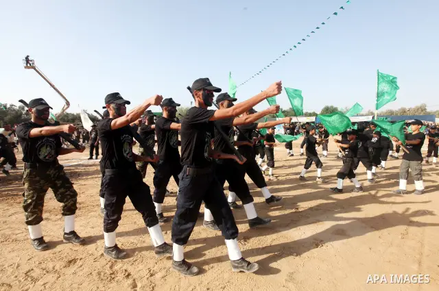 New graduates of a Palestinian Hamas military camp, ages 12-18, perform mock exercises during a graduation ceremony in Gaza City, on July 29, 2011. Photo by Majdi Fathi