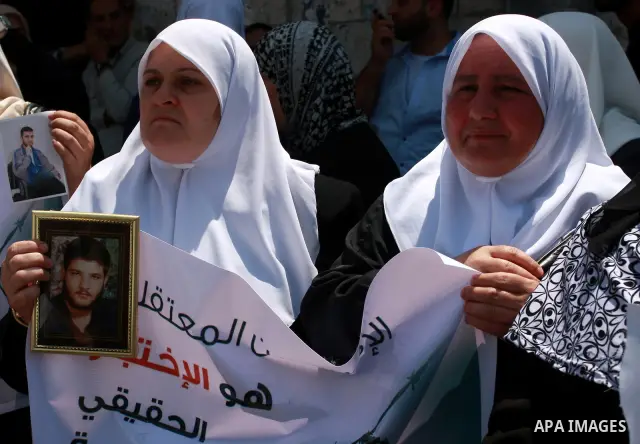 Palestinian women attend a protest demanding the release of arrested and imprisoned family members held for political reasons by the Palestinian Authority Security Forces, in the West Bank city of Nablus, on July 30, 201...