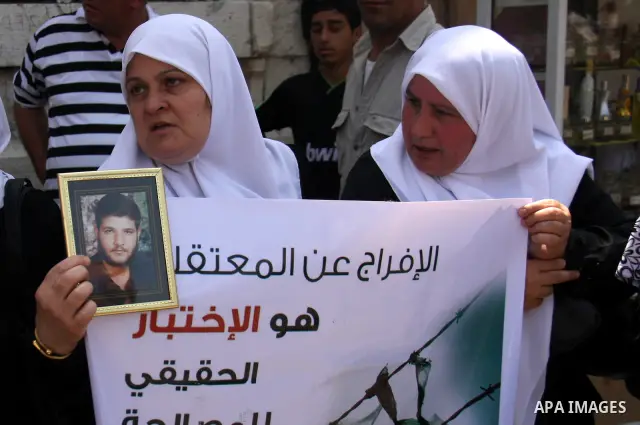 Palestinian women attend a protest demanding the release of arrested and imprisoned family members held for political reasons by the Palestinian Authority Security Forces, in the West Bank city of Nablus, on July 30, 201...