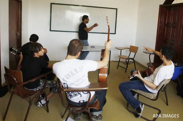 A Palestinian boy plays on musical instruments at the Gaza College in the Department of Music in Gaza city on July 30, 2011. Photo by Mahmud Nassar