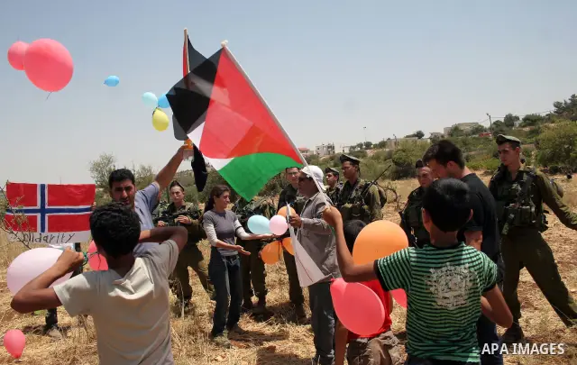 Palestinian protesters argue with Israeli soldiers during a demonstration against Israel's controversial separation barrier in the West Bank village of Beit Omar, near Hebron, 30 July 2011. Israel says the network of ste...