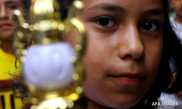A Palestinian girl buys a lantern ahead of the upcoming Muslim holy fasting month of Ramadan in Gaza City, on July 30, 2011. Ramadan falls in the ninth month of the Islamic calendar. Muslims observing fasting during this...