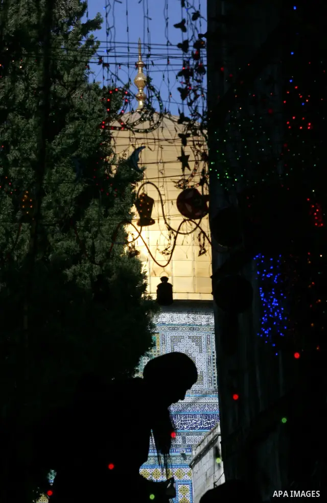 Palestinians walks under decorations ahead of the Muslim holy month of Ramadan in Jerusalem's Old City July 30, 2011. Muslims around the world abstain from eating, drinking and sexual relations from sunrise to sunset dur...