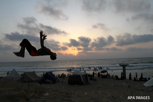 A Palestinian boy enjoys practicing jump on the beach in Gaza City, on July 30, 2011. Photo by Mohammed Asad