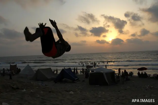 A Palestinian boy enjoys practicing jump on the beach in Gaza City, on July 30, 2011. Photo by Mohammed Asad