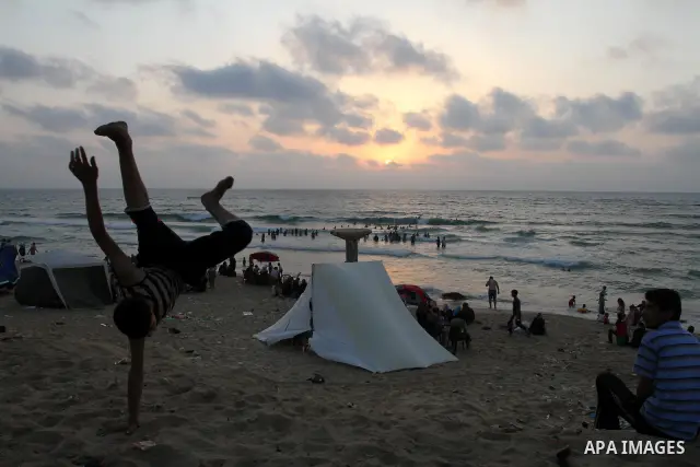 A Palestinian boy enjoys practicing jump on the beach in Gaza City, on July 30, 2011. Photo by Mohammed Asad