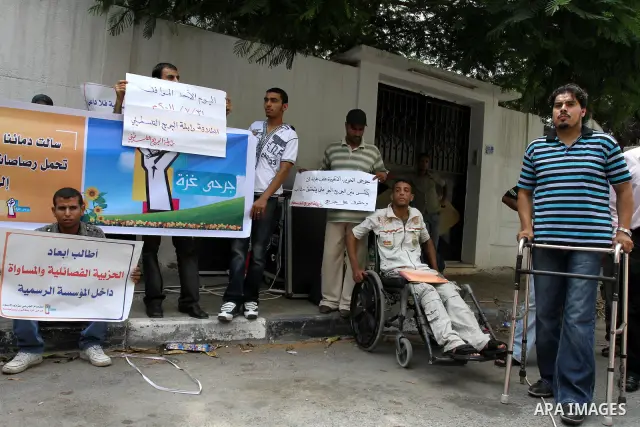 Palestinians wounded, take part in a protest demanding the authority of Ramallah to grant them their rights and entitlements in Gaza city on July 31, 2011. Photo by Mohammed Asad