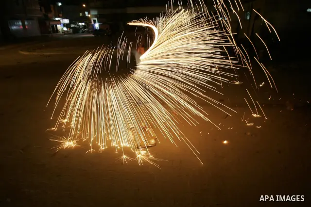 A Palestinian boy plays with fire crackers celebrating ahead of the Muslim holy month of Ramadan, in Rafah, southern Gaza Strip on July 30, 2011, where today is the complement of the month of Sha'ban, and tomorrow is the...