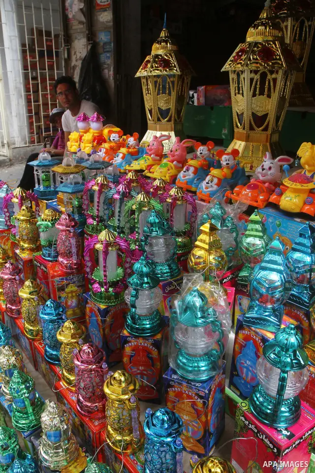 A Palestinian boy hangs lanterns outside his shop ahead of the Muslim holy fasting month of Ramadan at Al-Zawiya market in Gaza City on July 31, 2011. Photo by Ashraf Amra