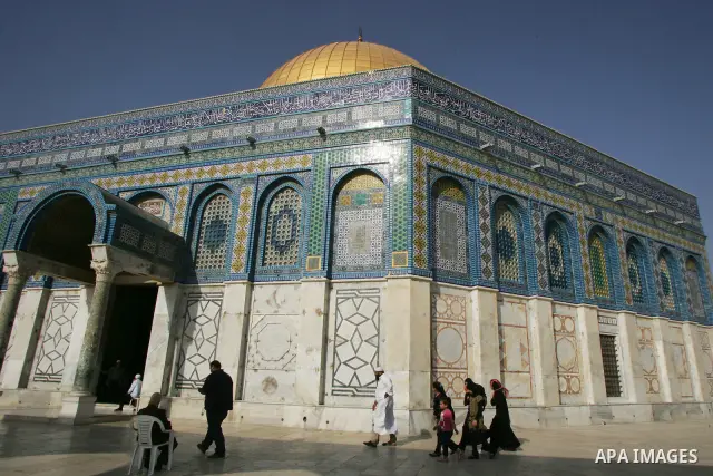 Palestinians are walk at the entrance of the Al-Aqsa mosque compound, in the old city of Jerusalem, on July 31 2011, as people ready for the upcoming Muslim holy fasting month of Ramadan. Photo by Mahfouz Abu Turk