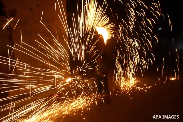 A Palestinian boy plays with fire crackers celebrating ahead of the Muslim holy month of Ramadan, in Der El-Balah southern Gaza Strip on July 31, 2011, where today is the complement of the month of Sha'ban, and tomorrow...