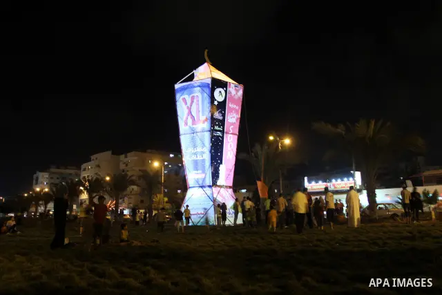 Palestinians sit and walk around a giant lantern set to mark the Muslim holy fasting month of Ramadan on July 31, 2011 in Gaza City. Photo by Mohammed Asad