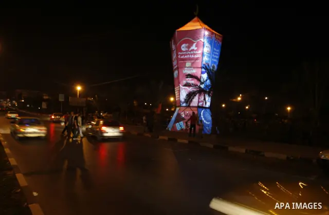 Palestinians sit and walk around a giant lantern set to mark the Muslim holy fasting month of Ramadan on July 31, 2011 in Gaza City. Photo by Mahmud Nassar