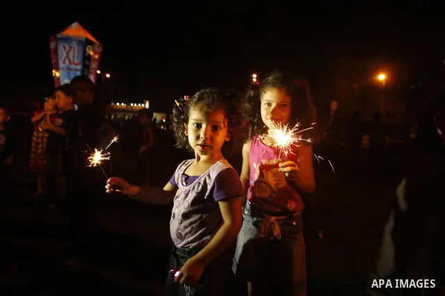 Palestinians sit and walk around a giant lantern set to mark the Muslim holy fasting month of Ramadan on July 31, 2011 in Gaza City. Photo by Mahmud Nassar